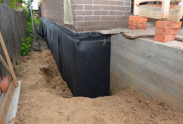 SJ Waterproofing Pros technician performing targeted Wet Basement Repair assessment in Berea, KY